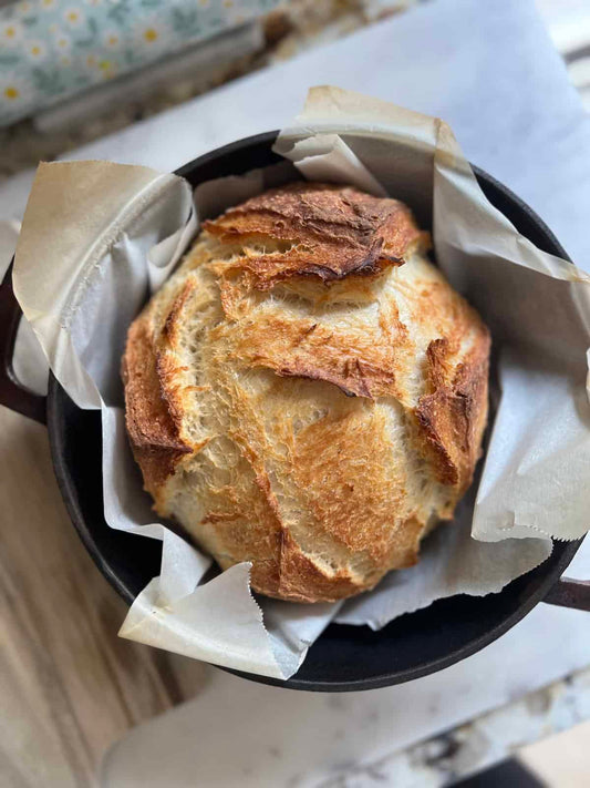 Crusty Artisan Bread in a Dutch oven on top of the counter