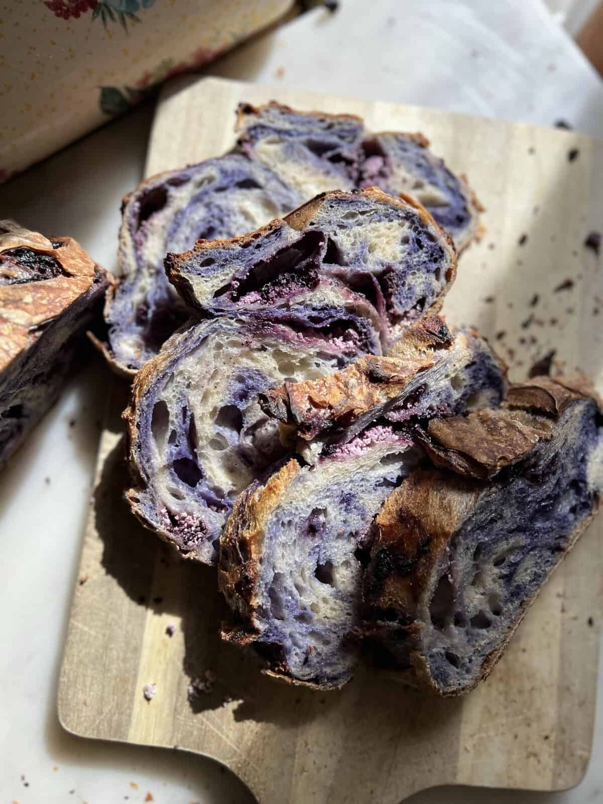 blueberry sourdough sliced and placed on a cutting board