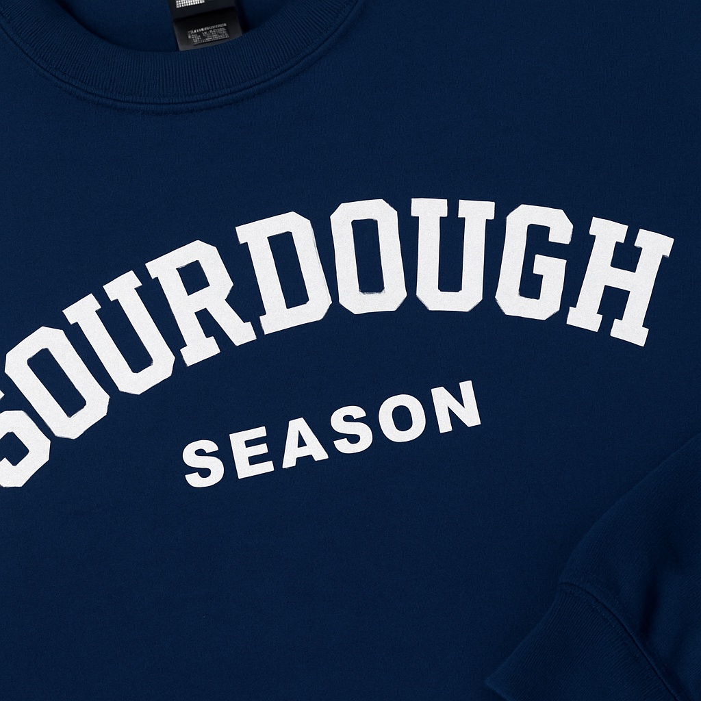 Navy blue sweatshirt with 'SOURDOUGH SEASON' text in white