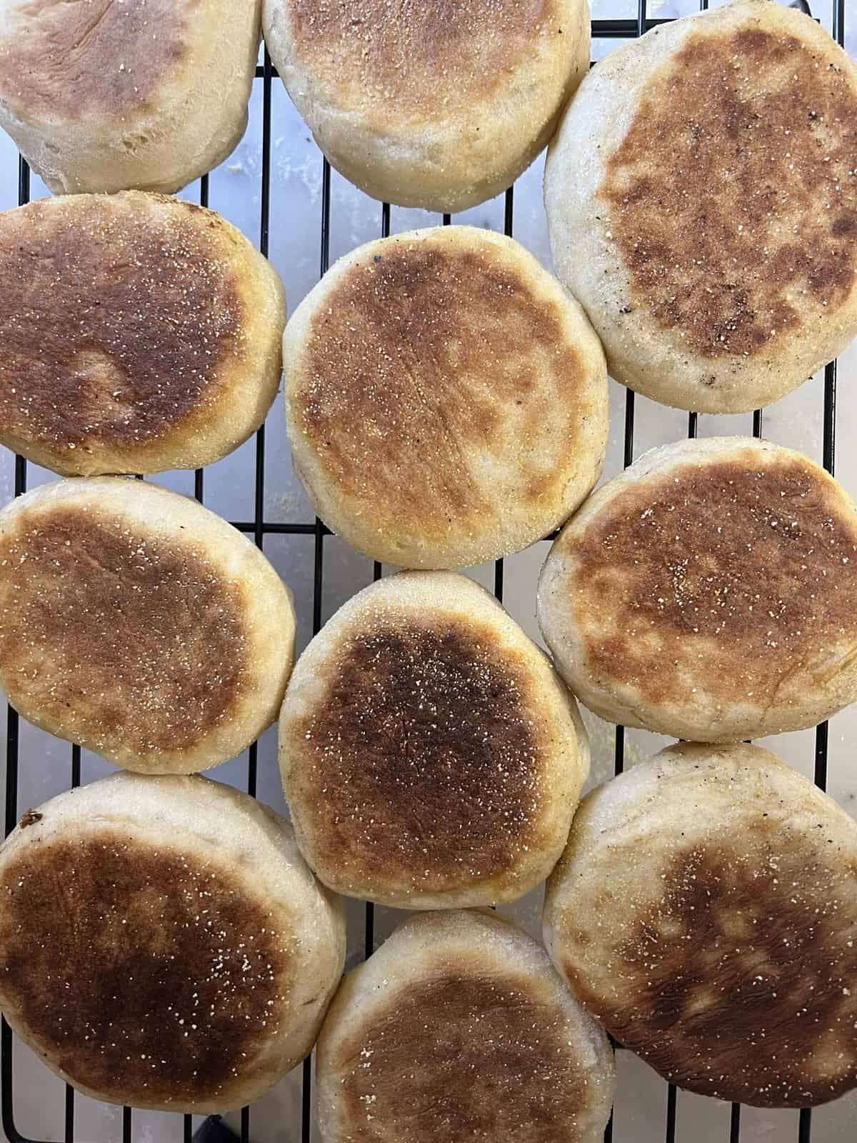 Sourdough english muffins on a wire cooling rack